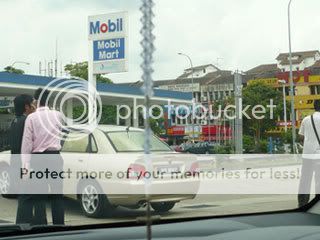 Young people harasing cars at the petrol station